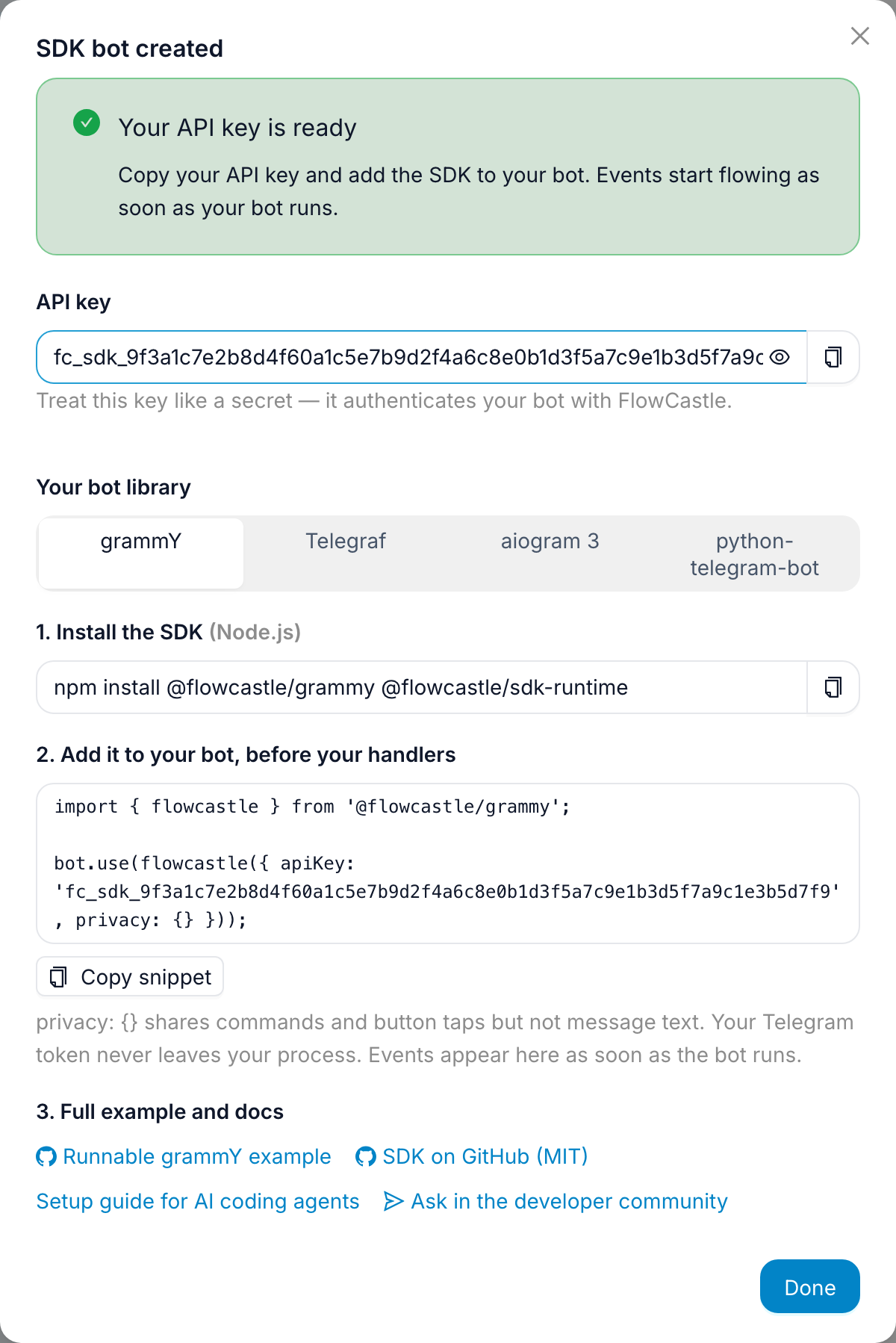 The SDK bot created: API key, a library picker set to grammY, the install command and a three-line integration snippet